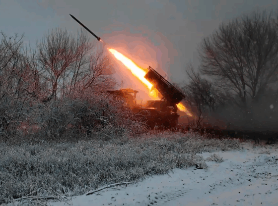 Missile launch from a military vehicle in a snowy field.